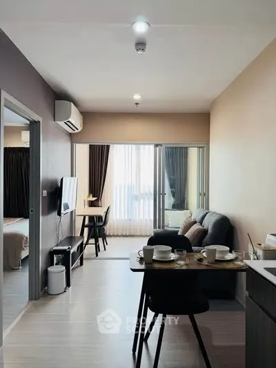 Modern living room with open layout, stylish furniture, and natural light from large windows.