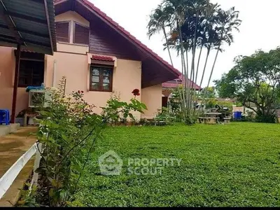 Charming suburban home with lush garden and tropical trees, perfect for family living.