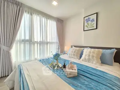 Cozy bedroom with soft blue accents and natural light