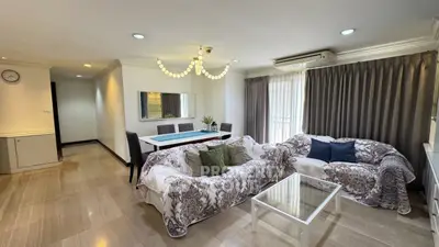 Spacious living room with elegant decor and ample natural light in a modern apartment.