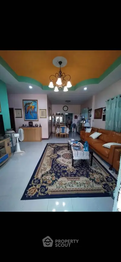 Spacious living room with elegant decor and vibrant ceiling design