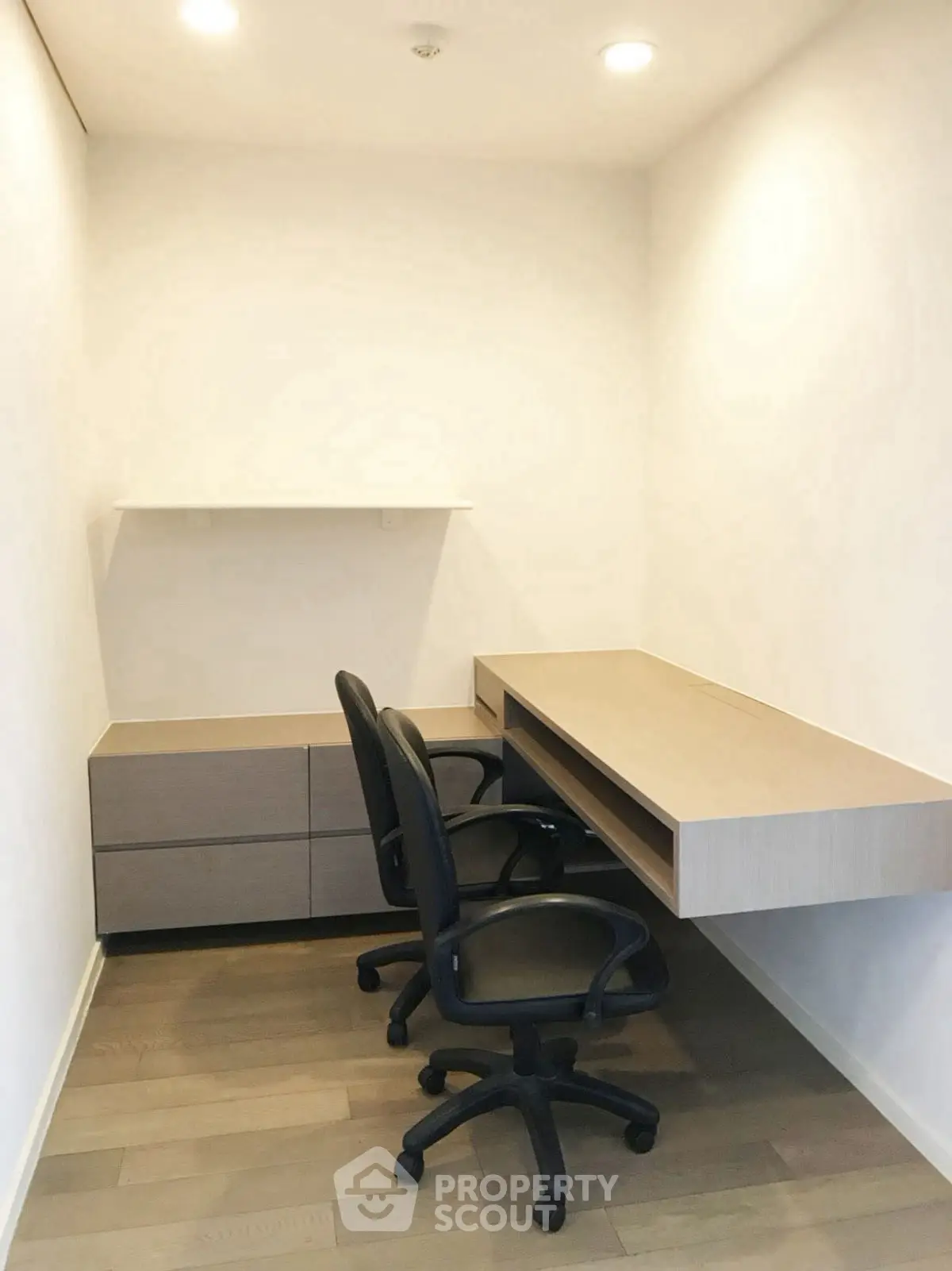 Modern study room with sleek desk and chairs, perfect for productivity.