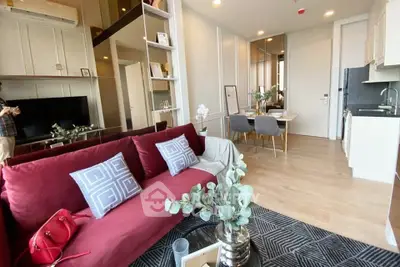 Modern open-plan living room with stylish decor and dining area in a cozy apartment.