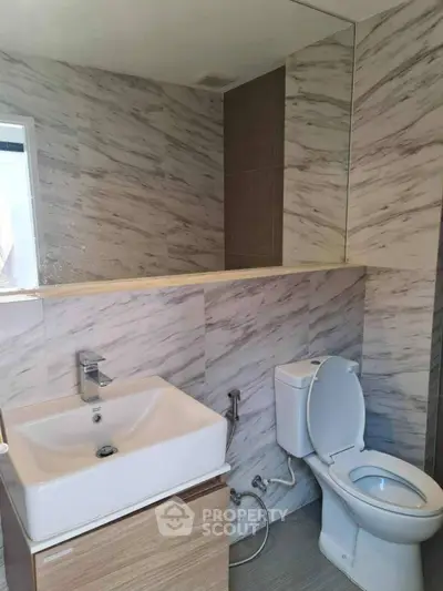 Modern bathroom with marble tiles and sleek fixtures