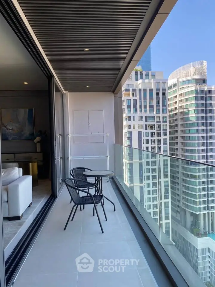 Luxurious high-rise balcony with stunning cityscape views and modern outdoor seating.