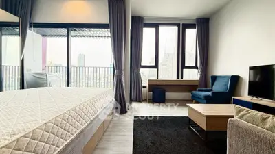 Spacious modern bedroom with city view and balcony access