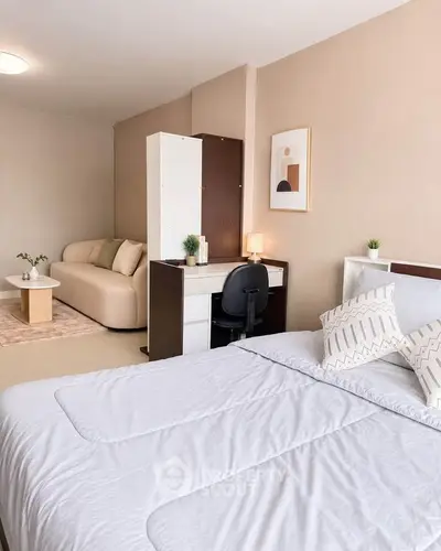 Cozy bedroom with modern decor and study area, perfect for urban living.