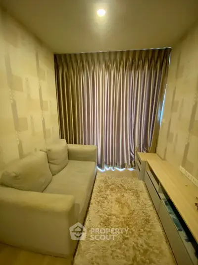 Cozy living room with plush sofa and elegant curtains in modern apartment