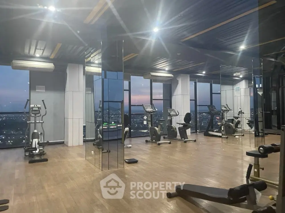 Spacious modern gym with panoramic city views and state-of-the-art equipment