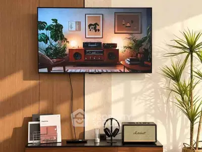 Stylish living room with modern decor and entertainment setup, featuring a wall-mounted TV and elegant furnishings.