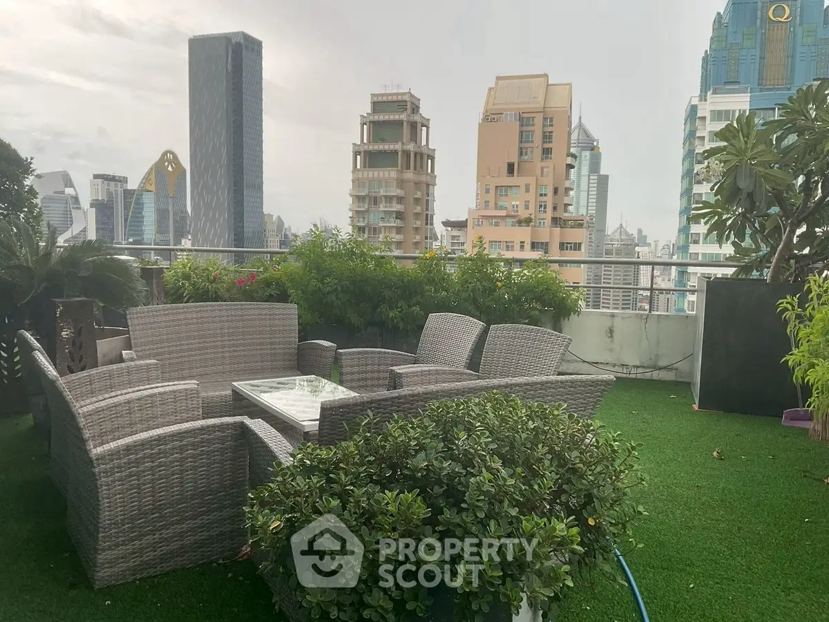 Stunning rooftop garden with city skyline views and cozy seating area.
