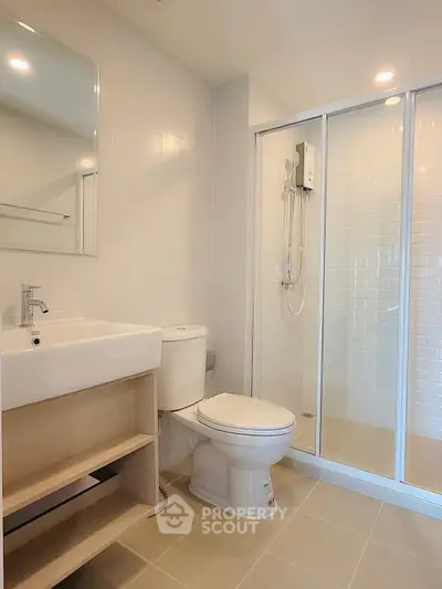 Modern bathroom with glass shower and sleek fixtures
