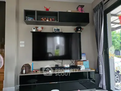 Modern living room with wall-mounted TV and stylish shelving