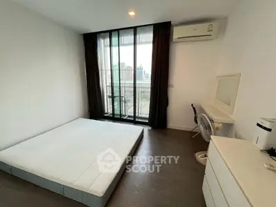 Modern minimalist bedroom with balcony view and air conditioning