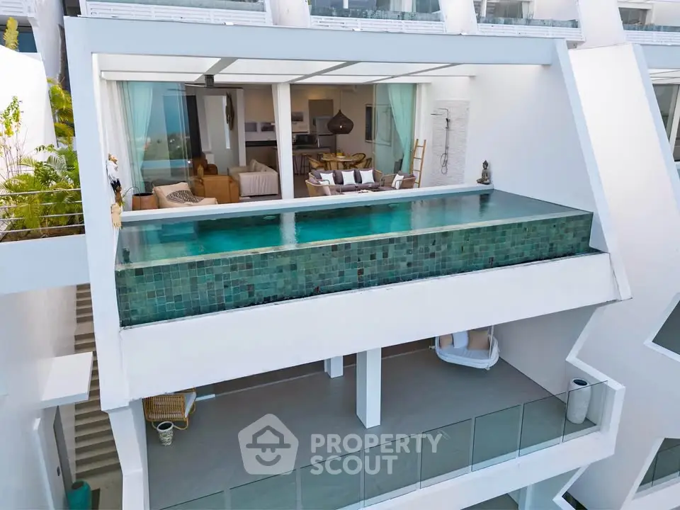 Luxurious modern villa with infinity pool and spacious balcony overlooking scenic views