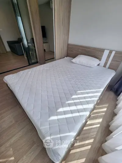 Modern bedroom with wooden flooring and large bed in a stylish apartment