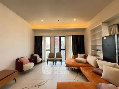 Spacious modern living room with stylish furniture and large windows offering city views.