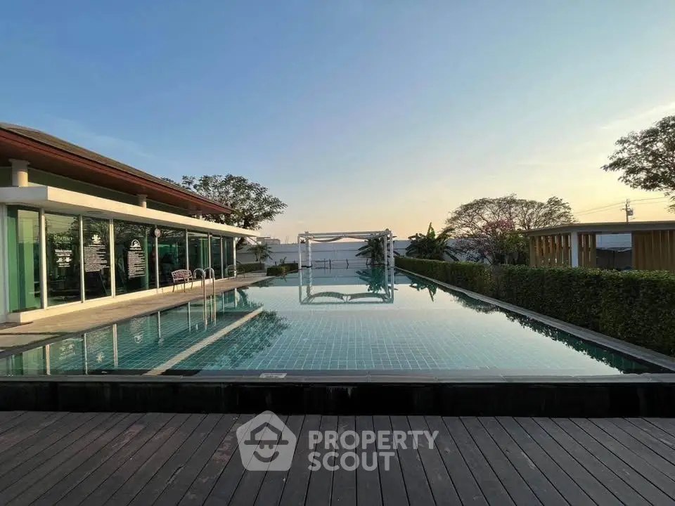 Luxurious rooftop pool with stunning sunset view and modern architecture.