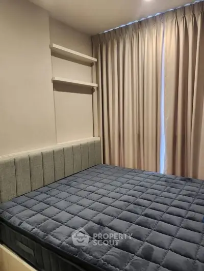Cozy bedroom with modern design and elegant curtains, perfect for relaxation and comfort.