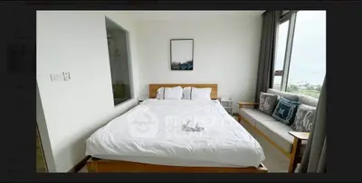 Spacious bedroom with modern decor and large window offering scenic views, perfect for relaxation.
