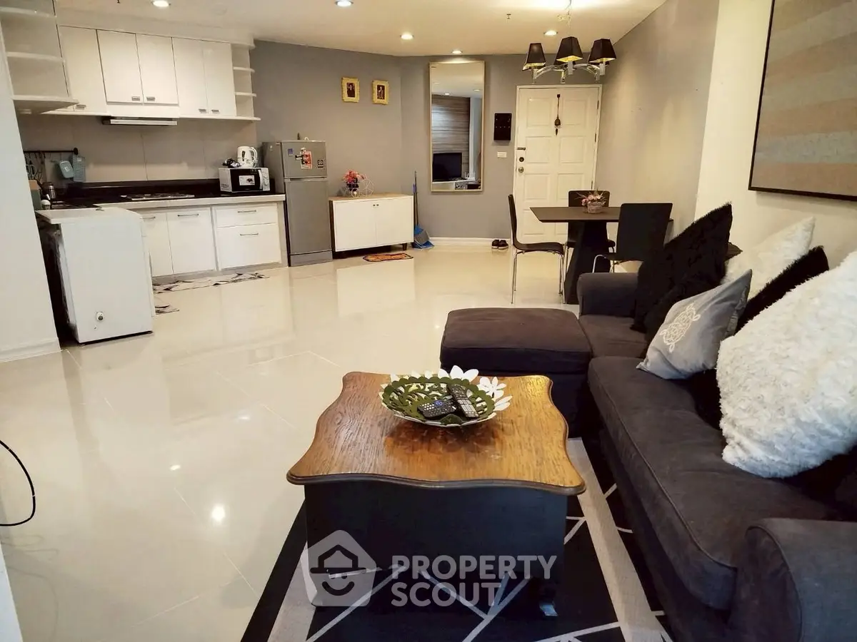 Spacious open-plan living room with modern kitchen and cozy seating area