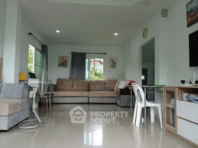 Spacious living room with modern furniture and large windows for natural light.