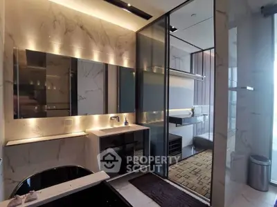 Luxurious modern bathroom with marble finishes and sleek glass shower