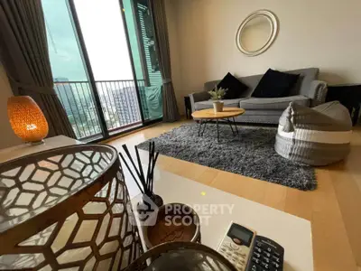 Stylish living room with cozy decor and balcony view in modern apartment