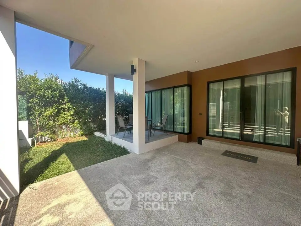 Modern home exterior with spacious patio and lush garden view