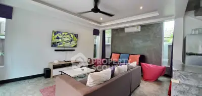 Modern living room with stylish decor, ceiling fan, and wall-mounted TV, perfect for relaxation and entertainment.