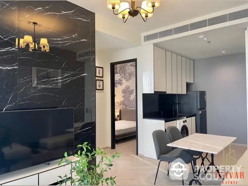 Chic modern apartment with sleek black marble wall accent, open layout kitchen, and inviting living space leading to a cozy bedroom.