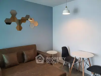 Modern living room with stylish hexagonal mirrors and cozy seating area.