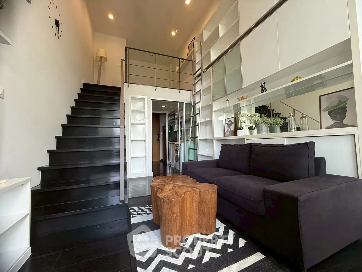 Modern loft-style living room with mezzanine, sleek staircase, and stylish decor.