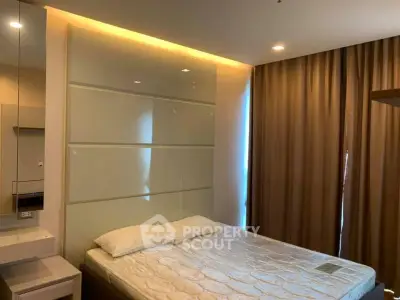Modern bedroom with stylish lighting and elegant curtains in a contemporary apartment.