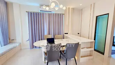 Modern dining area with elegant marble table and stylish chairs in a bright, airy room.