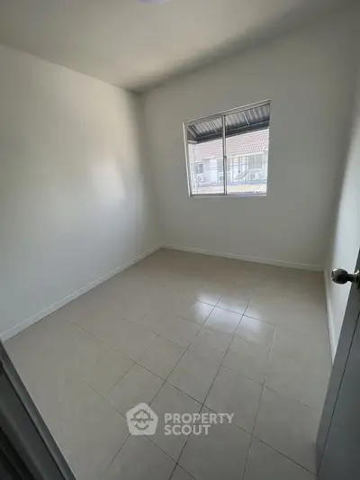 Minimalist empty room with tiled floor and window, perfect for customization.