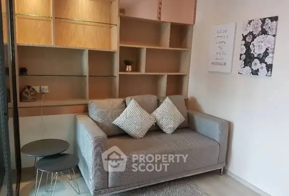 Cozy living room with modern sofa and stylish shelving in a chic apartment.