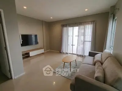 Spacious living room with modern decor and natural light