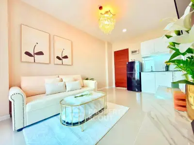 Elegant living room with modern decor and stylish kitchen in open layout apartment.