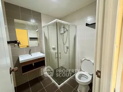 Modern bathroom with glass shower enclosure and sleek fixtures