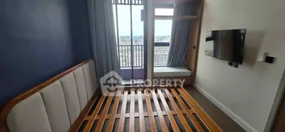 Modern bedroom with city view, featuring a wooden bed frame and wall-mounted TV.