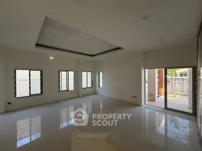 Spacious unfurnished living room with large windows and glossy floors