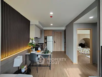 Modern open-plan living area with stylish kitchen and cozy dining space