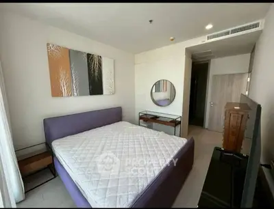 Modern bedroom with stylish decor and large bed in a contemporary apartment.