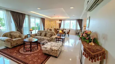 Luxurious living room with elegant decor and spacious layout, featuring large windows and stylish furniture.