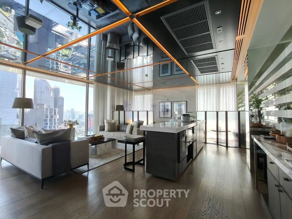 Luxurious modern living room with open kitchen and stunning city view, featuring sleek design and high-end finishes.