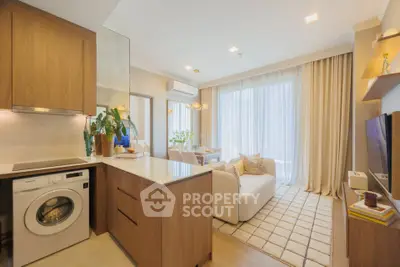 Modern open-plan living room with washing machine and elegant decor