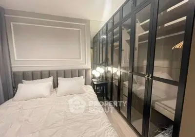 Luxurious bedroom with elegant glass wardrobe and plush bedding