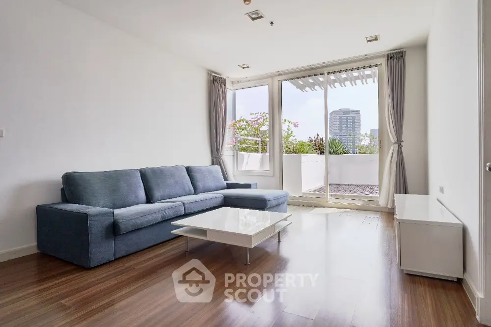Spacious modern living room with large windows and city view