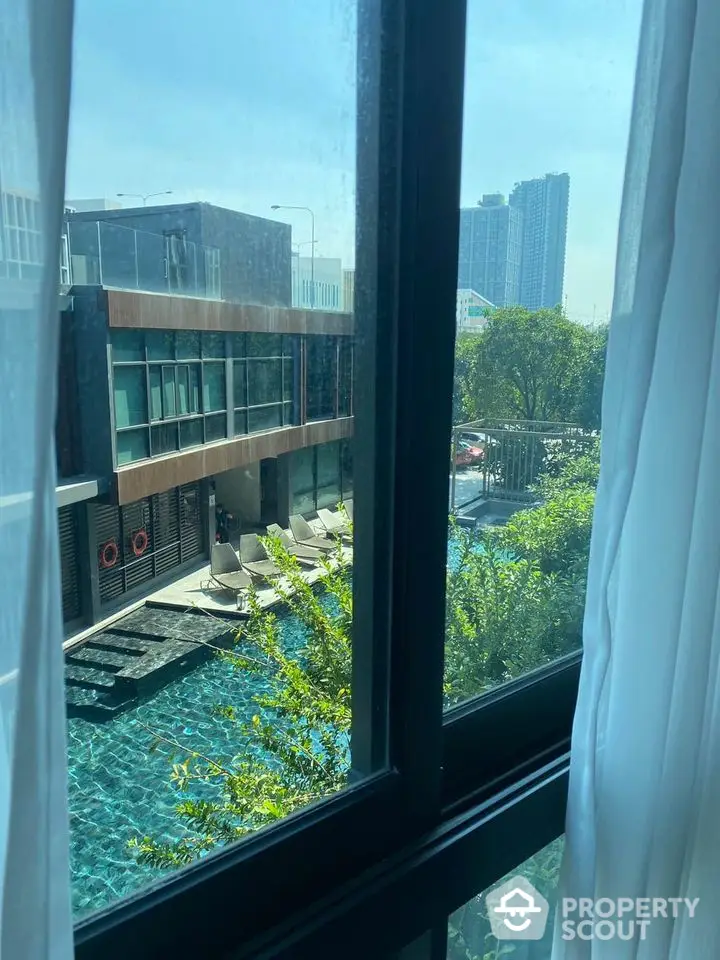 Luxurious pool view from modern apartment window